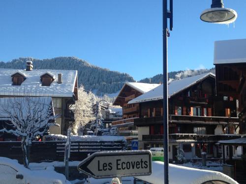 a street sign in a town with snow covered buildings at Chalet la Griotte in Villars-sur-Ollon