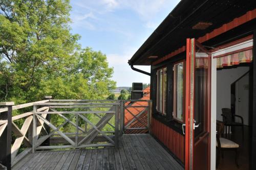 a porch of a house with a wooden deck at Husby Säteri in Söderköping