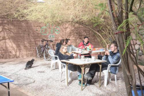a group of people sitting at a table at Hostal Sonchek in San Pedro de Atacama