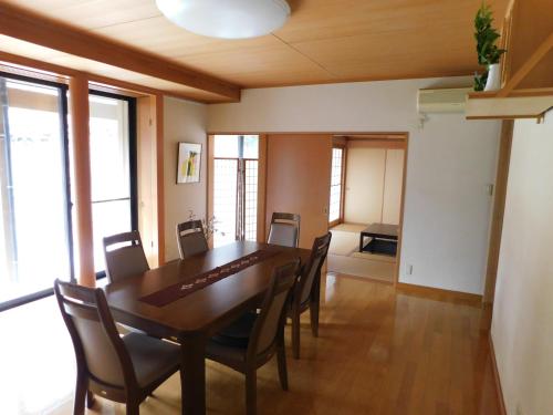 a dining room with a table and chairs at Nouka Minsyuku Hyousa in Minamiechizen