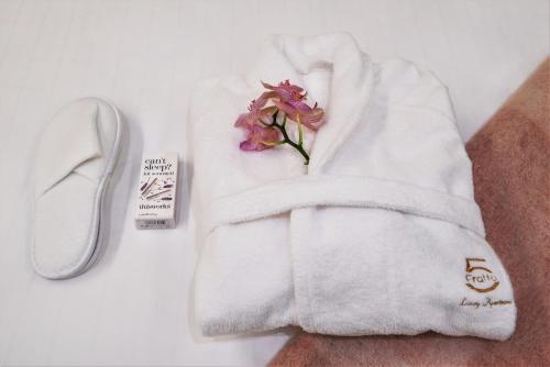 a white towel with a flower on top of it at Fratta5 Luxury Apartment in Verona