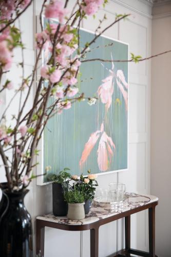 a table with pink flowers and a painting on the wall at The Cadogan, A Belmond Hotel, London in London