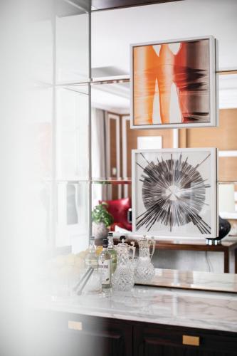 a kitchen counter with a picture on the wall at The Cadogan, A Belmond Hotel, London in London