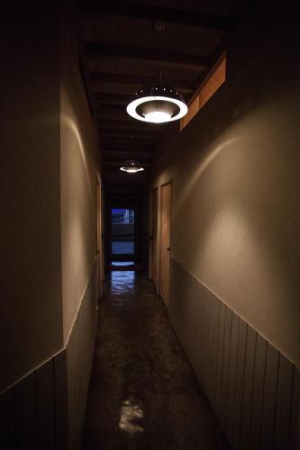 a dark hallway with a light fixture on the ceiling at May Rooms Taipei Nangang Station in Taipei