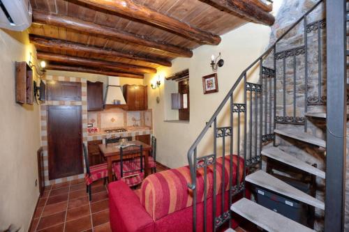 a living room with red chairs and a staircase at Al Castello in Brolo