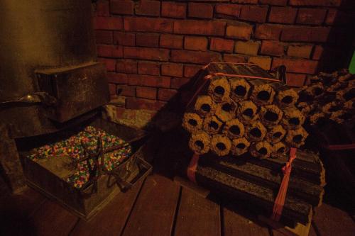 a room with a brick wall and a box of candy at May Rooms Taipei Nangang Station in Taipei