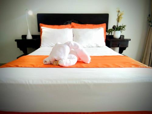 a stuffed animal is laying on a bed at Hotel el Atajo in Yopal