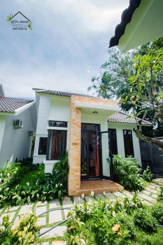 a villa with a garden and a house at Hoàng Ngọc's House in Tuy Hoa