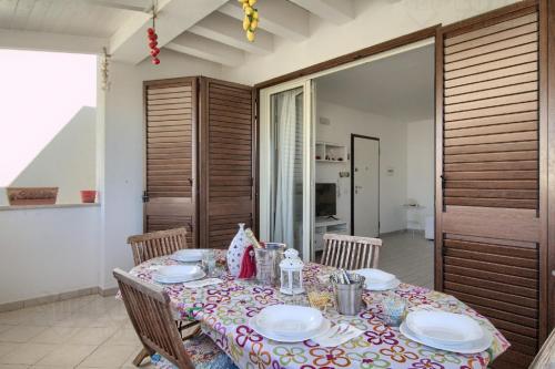 a table with plates on it in a room at Starfish Apt by LoveSud in Leuca