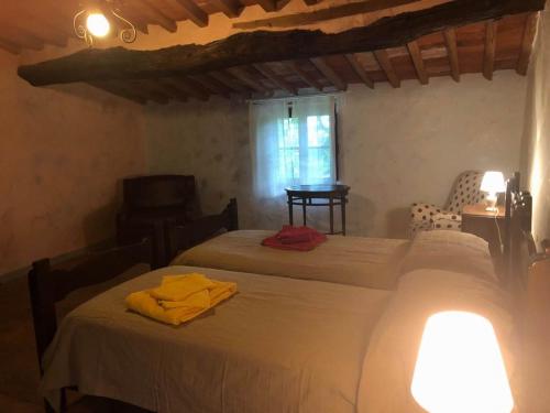 a bedroom with two beds and a window at La Grazia della Versilia in Santa Lucia