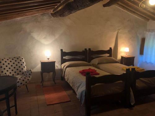a bedroom with two beds and two tables and two lamps at La Grazia della Versilia in Santa Lucia