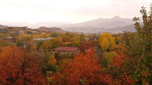 a city in the fall with trees and mountains at B&B Ruzan in Yeghegnadzor