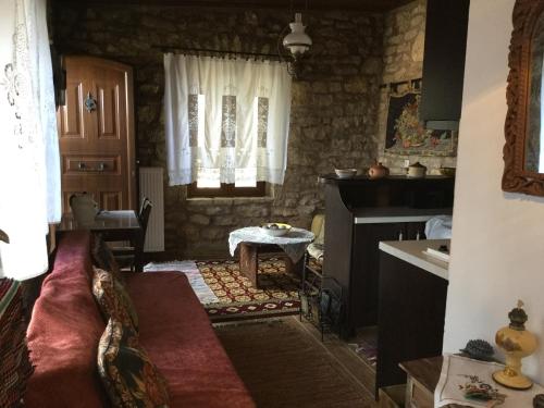 a living room with a couch and a kitchen at Filia House - Kalavryta in Klitoria