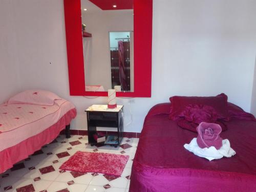 a bedroom with two beds and a mirror at Villa Toledo TCV in Trinidad