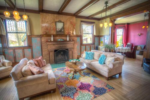 a living room with two couches and a fireplace at Lauerman House Inn Bed & Breakfast in Marinette