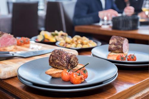 a table with plates of food on top at Schlossberg Hotel Homburg in Homburg
