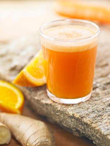 a glass of orange juice next to orange slices at Reykjavik Natura - Berjaya Iceland Hotels in Reykjavík
