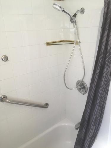 a shower in a bathroom with a shower curtain at Beach Townhouse in St Thomas