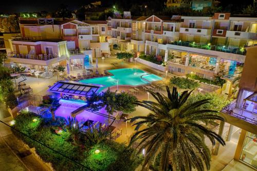 an aerial view of a hotel with a pool at night at Heliotrope Hotels in Mytilene