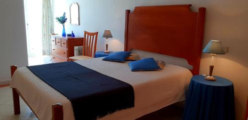 a bedroom with a large bed with blue pillows at Varandas do Mar by Sunny Deluxe in Albufeira