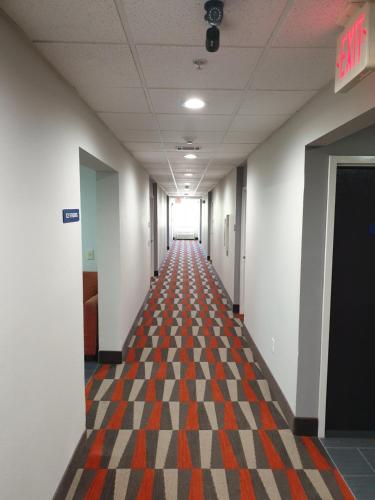 a hallway of an office with a checkered floor at Microtel Inn & Suites by Wyndham Augusta/Riverwatch in Augusta