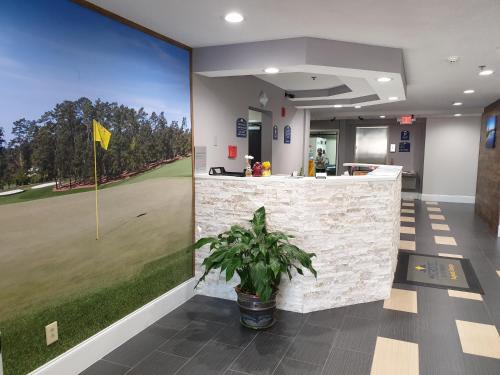 an office with a golf course mural on the wall at Microtel Inn & Suites by Wyndham Augusta/Riverwatch in Augusta
