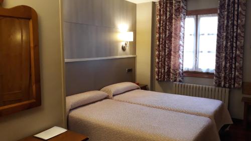 Ένα ή περισσότερα κρεβάτια σε δωμάτιο στο Hotel Aragüells