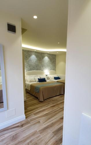 a large bedroom with two beds and a wall at Ines bed and breakfast in Giardini Naxos