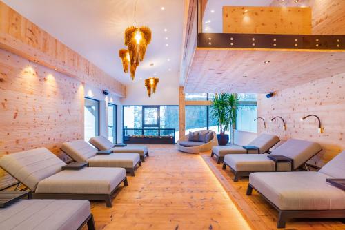 a waiting room with couches and chairs in a building at Gaspingers Bergjuwel in Gerlos