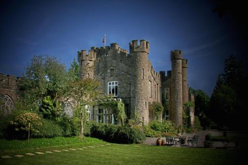 an old castle with a flag on top of it at Augill Castle in Kirkby Stephen