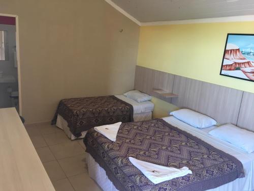 Una cama o camas en una habitación de Hotel Pousada Latitude