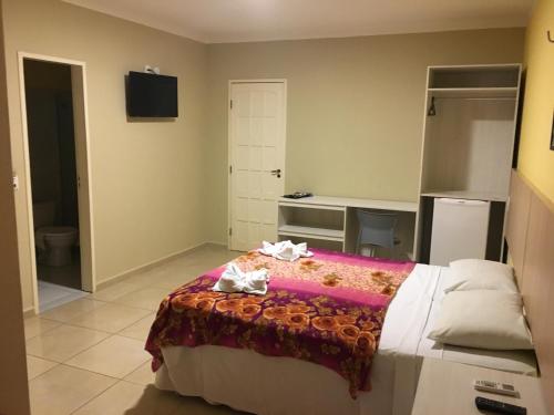 Una cama o camas en una habitación de Hotel Pousada Latitude