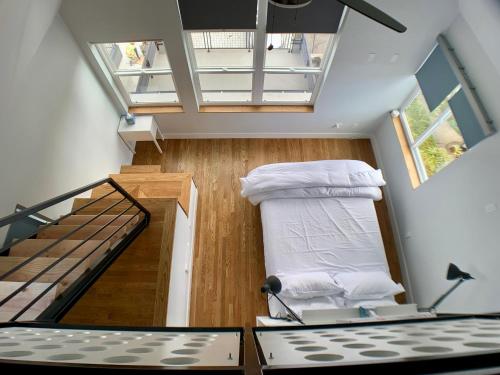 a small room with a bed and a staircase at Birdhouse on Green Lake in Seattle