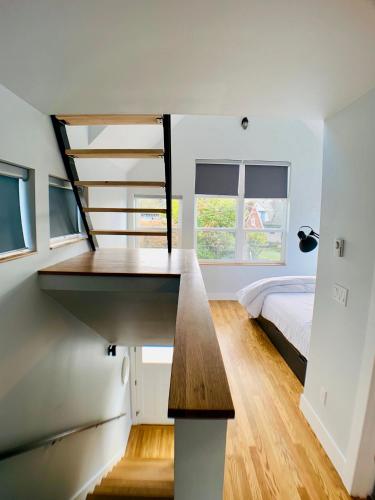 a bedroom with a bed and a desk in a room at Birdhouse on Green Lake in Seattle
