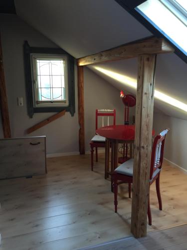 a room with a table and chairs in a attic at Ferienwohnung „Kleine Liebe“ in Bad Schandau