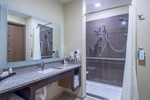 a bathroom with a sink and a shower at Cobblestone Inn & Suites - St Marys in Saint Marys