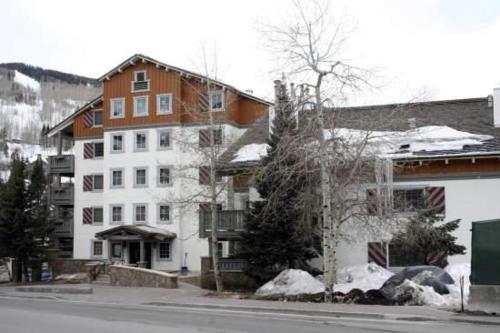 a large white building on a street with snow at Condo with Hot Tub Free Garage Parking in Vail