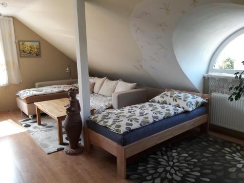 a living room with a bed and a couch at Apartmán Ludmila in Hlohovec