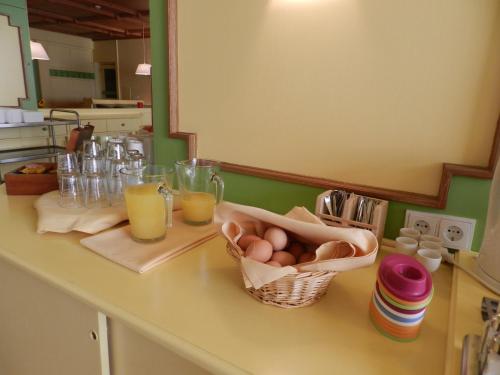 a kitchen counter with eggs and glasses of orange juice at Hotel YOUHEY am Wolfgangsee in Strobl