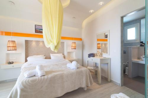 a bedroom with a large bed with towels on it at Villa Adriana Hotel in Agios Prokopios