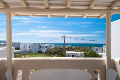 a balcony with a table and a view of the ocean at Villa Adriana Hotel in Agios Prokopios