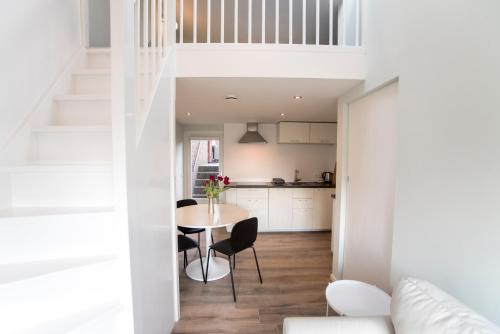 a kitchen and dining room with a table and chairs at New Point in Zandvoort