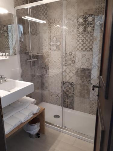 a bathroom with a shower and a sink at Family Hotel Schloss Rosenegg in Fieberbrunn