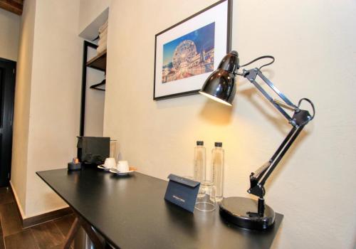 a desk with a lamp on top of it at Antigua Trece Hotel Fusión in Guanajuato