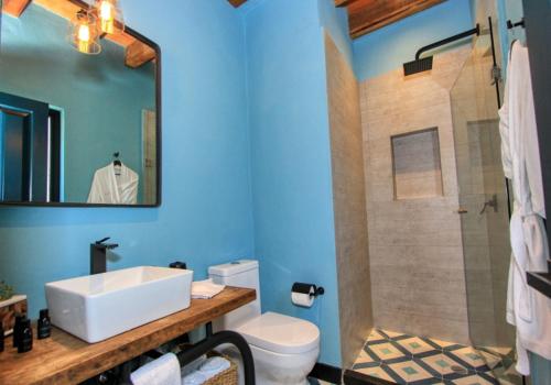 a bathroom with a sink and a toilet and a shower at Antigua Trece Hotel Fusión in Guanajuato