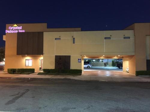 a large building with a parking garage at night at Crystal Palace Inn in Maywood