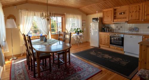 a kitchen with a table and a dining room at Iverhjelen Near Atlantic Road in Lyngstad