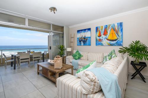 a living room with a view of the ocean at Sands Beach Breaks Luxury Beach Front Ballito in Ballito