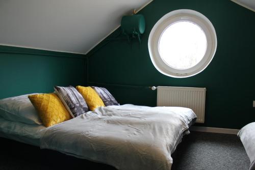 a bedroom with a bed and a round window at Dworek Zakopane in Zakopane