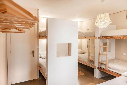 a small room with bunk beds and a door at Wild House Tarifa in Tarifa